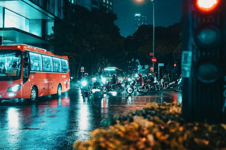 bus running in front of motorcycle riders
