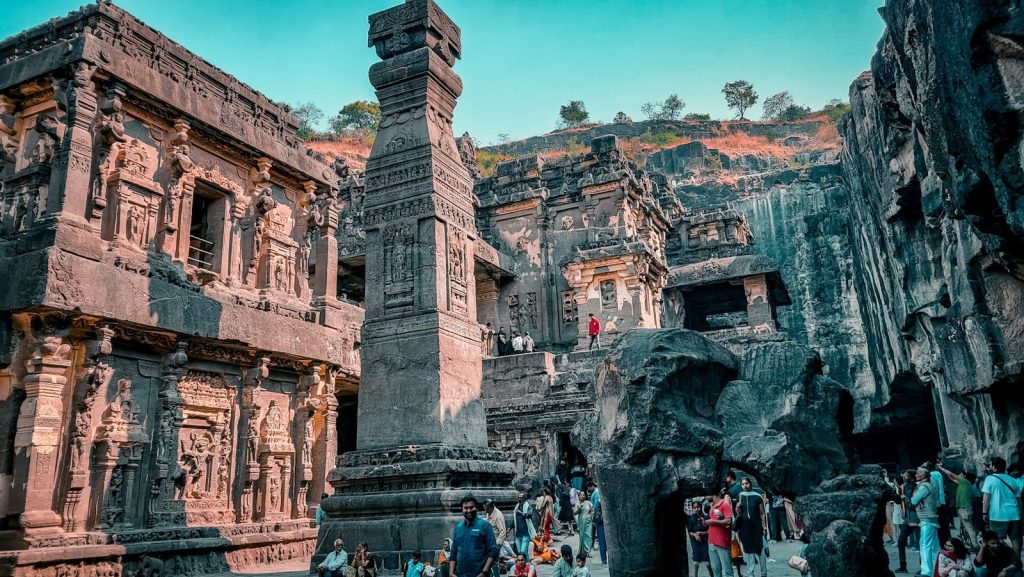 a group of people standing around a stone structure