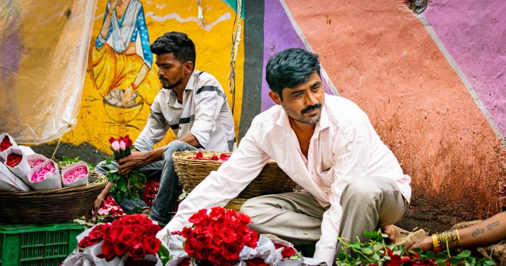 a couple of men sitting next to each other